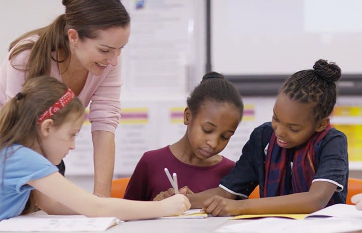 odyssey2 teaching assistant helping students learn french in a classroom